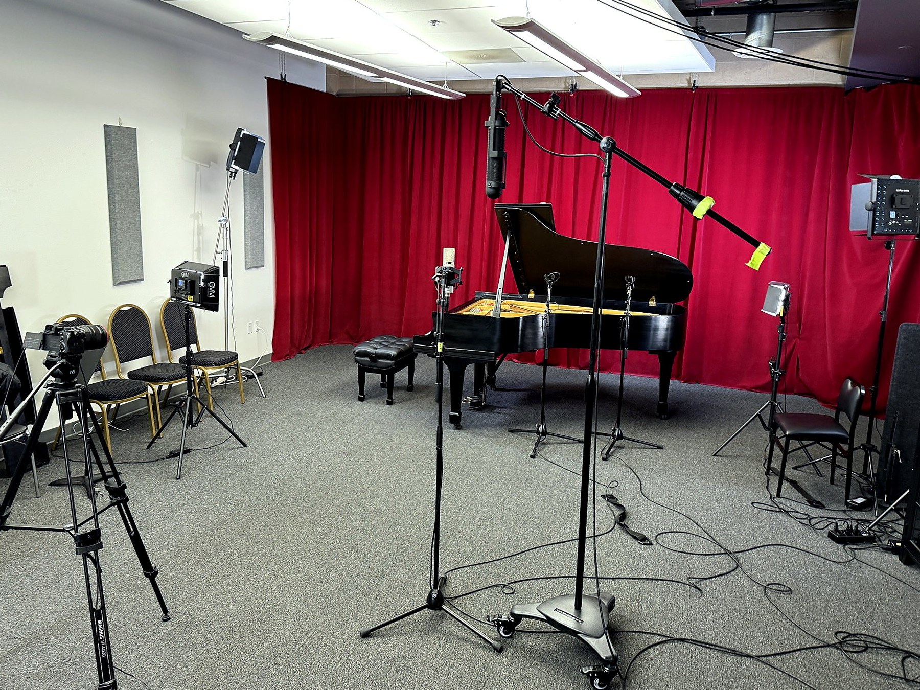 Our Irvine recording room with a grand piano, microphones and filming equipment